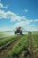 A man standing in a field with a sprinkle of water. Agriculture land