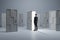 Man standing in front of abstract white puzzle door in interior. Future, choice, success, direction, opportunity and solution