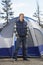 Man Standing In Front Of Camping Tent