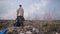 Man standing on garbage hill at landfill site