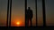 Man standing glass doors of the house at sunset