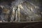 Man standing beside a group of stalactite cave 2