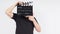 A man is standing with hands is holding black Clapperboard or movie slate. it use in video production ,film, cinema industry.It is