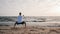 Man standing in horse stance Ma Bu while morning training WuShu on sea shore
