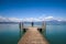 Man standing on a jetty by tranquil lake