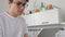 Man standing in kitchen with electronic tablet. Good looking man at home drinking coffee using digital tablet happy loft