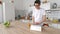Man standing in kitchen with electronic tablet. Good looking man at home drinking coffee using digital tablet happy loft