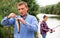 Man standing on lake shore with hook fish