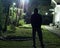 Man standing on a lawn looking at the stars in the night sky during a cold winter night. long exposure shot of a man wearing his w