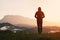 Man standing looking at Mount Kinabalu on sunrise.