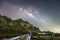 A man standing among milky way and mountain, Thailand