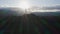 A man standing on a mountain peak in rays of evening sun. Aerial drone footage of a male traveler on top of mount in