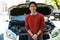 Man standing near car with bonnet open