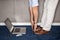 Man standing in office doing exercises with laptop