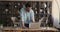 Man standing in office lean over desk working on laptop