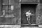 Man standing on old factory building loading dock playing acoustic guitar