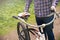 Man standing outside holding bike