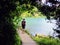 Man standing on a pathway by a remote lake thinking and contemplating