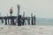 Man standing at the pier and watching the ocean