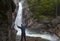 Man Standing in praise in front of Glen Ellis Falls at Pinkham N