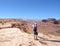 Man standing with raised arms enjoying time on hiking trip.