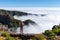 Man standing on rock`s edge above the clouds, Madeira, Portugal