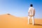 Man standing on a sand dune