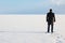 Man standing on the shore of a frozen sea downshifting way relax