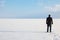 Man standing on the shore of a frozen sea downshifting way relax