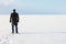 Man standing on the shore of a frozen sea downshifting way relax