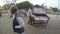 Man standing at street while another man moves mobile street stand to location.