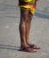 Man is standing on a street with wet legs stock photograph