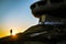A man standing in the sunset at Buzludzha Monument,