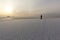 Man standing on the thin ice of a freezing pond