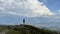 Man standing on top of the mountain relaxing and enjoying beautiful summer mountain landscape. A panoramic view of the