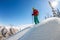 Man standing at top of ridge. Ski touring in mountains. Adventure winter freeride extreme sport