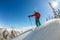 Man standing at top of ridge. Ski touring in mountains. Adventure winter freeride extreme sport
