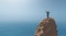 Man standing on top of a rock cliff