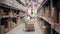 A man standing with a trolley with boxes on it, is checking his list and looking for necessary things in a warehouse