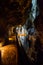 man standing in trummelbach falls, the biggest waterfall in Europe, inside a mountain accessible for public, Lauterbrunnen village