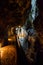 man standing in trummelbach falls, the biggest waterfall in Europe, inside a mountain accessible for public, Lauterbrunnen village