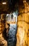 man standing in trummelbach falls, the biggest waterfall in Europe, inside a mountain accessible for public, Lauterbrunnen village