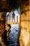 man standing in trummelbach falls, the biggest waterfall in Europe, inside a mountain accessible for public, Lauterbrunnen village