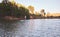 Man standing up on a paddle board on a quiet lake surrounded by trees in nature. Active man enjoying water sports on