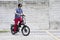 Man standing upright riding electric bike