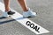 Man standing on white line with goal sign