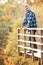 Man Standing On Wooden Balcony in Woodland