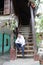 A man is standing on the wooden upstairs of a house with happy face