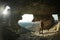 Man stands in a cave in the cave city of Mangup-Kale