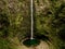 A man stands in front of the massive 100m high waterfall Levada do Caldeirao Verde on Madeira Island